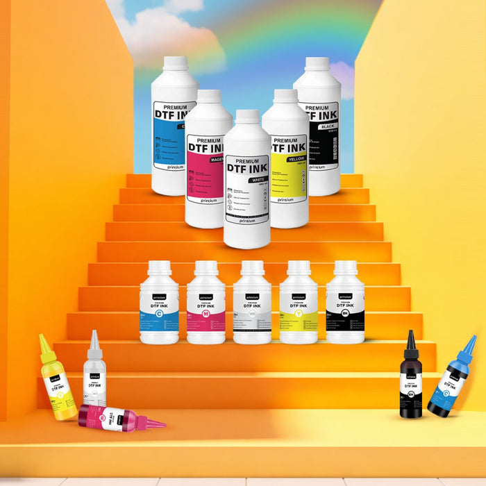 Assorted DTF ink bottles for printing on orange steps with a rainbow background